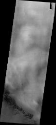 This image from NASA's Mars Odyssey spacecraft shows dark sand dunes found in Hellas Basin, location of the lowest elevations on Mars.