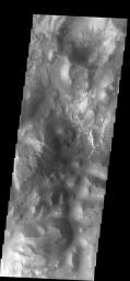 This image from NASA's Mars Odyssey spacecraft shows a small portion of Iani Chaos on Mars. The different tones and surface textures indicate that different types of material exist in this region.