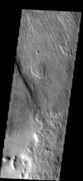 This image from NASA's Mars Odyssey spacecraft shows erosion and the removal of material in a region just southeast of Apollineris Patera on Mars. The material may be volcanic ash from the nearby patera.