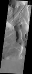 This image from NASA's Mars Odyssey spacecraft shows Noctis Labyrinthus located at the western end of Valles Marineris on Mars. This maze-like feature of deep intersecting valleys was formed by tectonic forces and extensive faulting.