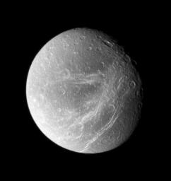 Bright, wispy fractures streak across Saturn's moon Dione's trailing side. This image was taken in visible light with NASA's Cassini spacecraft's wide-angle camera on Sept. 30, 2007.
