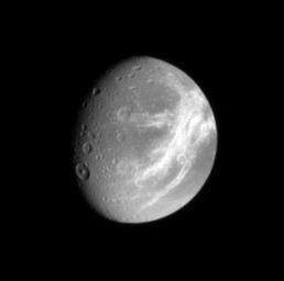 NASA's Cassini spacecraft catches a glimpse of the bright fractures that adorn the trailing side of icy Dione, a moon of Saturn.