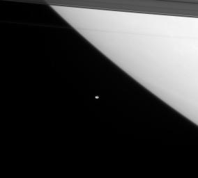 On Feb. 13, 2008, NASA's Cassini spacecraft provided a window on the awesome scale of the Saturn system, with the giant planet dominating one of its smaller satellites. Just outside the main ring system, orbits Janus.