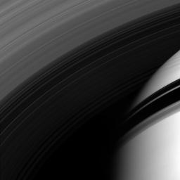 NASA's Cassini spacecraft peers through the gossamer strands of Saturn's innermost rings, whose own shadows adorn the planet beyond.