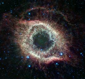 An expanded image of the Helix nebula lends a festive touch to the fourth anniversary of the launch of NASA's Spitzer Space Telescope.