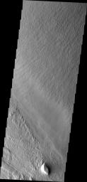 This image from NASA's Mars Odyssey spacecraft shows the Medusa Fossae Formation located east of the Tharsis volcanoes. The materials of the formation are easily eroded by the wind