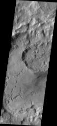 This image from NASA's Mars Odyssey spacecraft shows a crater located in near Sirenum Fossae and some of the modification of the crater may be related to the tectonic activity that created the fossae system.