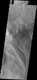 This image from NASA's Mars Odyssey spacecraft shows a portion of the floor of Ophir Chasma on Mars. At top is a landslide deposit. In the center is a wind and perhaps water eroded highland. At bottom wind appears to be the main agent of erosion.