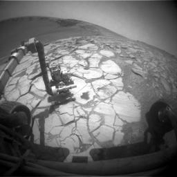 NASA's Mars Exploration Rover Opportunity used its front hazard-identification camera to capture this wide-angle view of its robotic arm extended to a rock in a bright-toned layer inside Victoria Crater on Oct. 13, 2007.