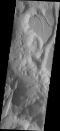 This image from NASA's Mars Odyssey spacecraft shows Timbuktu Crater on the margin of Capri Chasma, Mars. The crater hosts a variety of geologic features including fractures, channels, landslides and others.