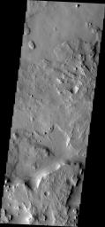 This image from NASA's Mars Odyssey shows a portion of Arabia Terra. There is an impact crater just out of the frame to the right and a larger one south of the frame; layering can be seen in the ejecta of both craters. 