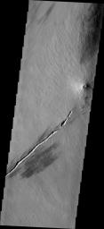 This image from NASA's Mars Odyssey shows a small volcanic construct located in the Tharsis region. The linear depression in lower part of the frame was likely a vent for lava flows; the summit vent of the volcano appears to align with the linear vent.
