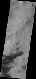 This image from NASA's Mars Odyssey shows small, dark dunes are located in Hellas Basin, within a region of chaotic terrain.