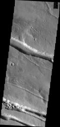 This image from NASA's Mars Odyssey shows linear depressions created by fault action. These features are located on the western margin of the Elysium Volcanic Complex.