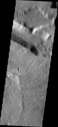 This image from NASA's Mars Odyssey shows a group of landslide deposits located in the lows between Aeolis Mensae and Aeolis Planum. Wind has eroded surface at the bottom of the frame.