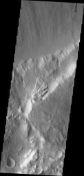 This image from NASA's Mars Odyssey shows a landslide deposit located on the northern side of Sharonov Crater, which has been modified by the flows within Kasei and Lobo Valles.