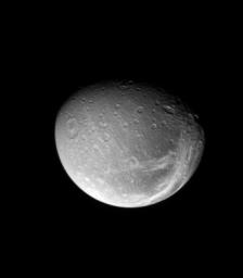 The bright fractures on Dione's trailing side slice across terrain that is darker than the rest of the surface. This image was taken in visible light with NASA's Cassini spacecraft's narrow-angle camera on May 17, 2008.