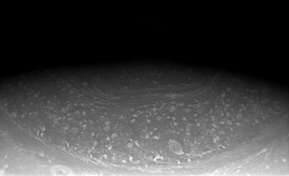 In the low light near Saturn's north pole, NASA's Cassini spacecraft captures a partial view of the planet's unique hexagonal feature.