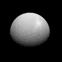 Rhea's bright ray crater features prominently in this southern view captured by NASA's Cassini spacecraft. The feature is surrounded by bright ejectamaterial thrown outward by the impact that formed the crater.