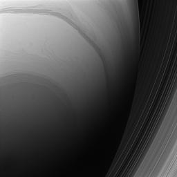 NASA's Cassini spacecraft looks upward at the swirling clouds of Saturn's southern hemisphere. The C and B rings are seen at right, beyond the planet's nightside limb.