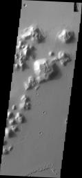 This image from NASA's Mars Odyssey shows dark slope streaks located on this small mesa in southern Amazonis Planitia.
