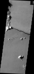 This image from NASA's Mars Odyssey shows Cerberus Fossae, comprised of several long fractures radial to the Elysium Volcanic complex. This fracture appears to have been a vent for some of the local lava flows.