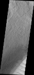 This image from NASA's Mars Odyssey shows the edge of an eroded deposit of material in Ophir Chasma.