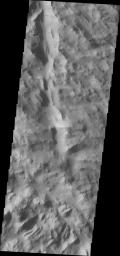 This image from NASA's Mars Odyssey shows dark, slope steaks, common in the heavily fractured material found to the north and west of Olympus Mons.