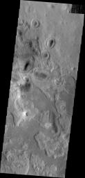 This image from NASA's Mars Odyssey shows many regions in the northern plainson Mars featuring evidence of layered materials.