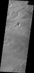 This image from NASA's Mars Odyssey shows many lava flows, part of the extensive Tharsis volcanic complex. These flows appear to originate in the region of Alba Patera and flowed downhill towards Olympus Mons.