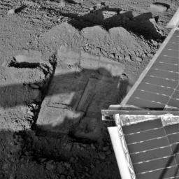 This image, acquired by NASA's Phoenix Mars Lander on July 7, 2008, shows the sample scraping area in the trench informally called 'Snow White' on Mars. Part of the lander is seen above the trench.