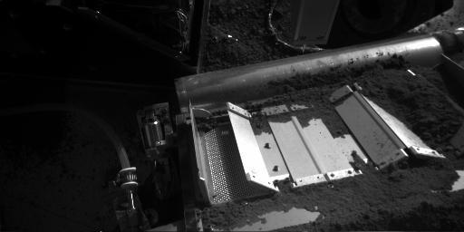 This image from NASA's Phoenix Mars Lander on Aug. 20, 2008 shows some of the soil on the screen beneath the doors and one of the cell's two doors is fully open.