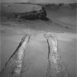 NASA's Mars Exploration Rover Opportunity climbed out of 'Victoria Crater' following the tracks it had made when it descended into the bowl nearly a year earlier in this image taken on Aug. 28, 2008.
