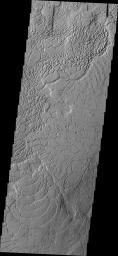 This image from NASA's Mars Odyssey shows Averuns Colles on Mars. These broken blocks and arcuate fractures mark the transition region between the southern highlands and the northern lowlands of Mars.