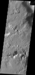 This image from NASA's Mars Odyssey shows channels located on the eastern and northern margins of Terra Sabaea on Mars. Dunes are located on the floor of the channel.