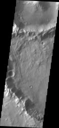 This image from NASA's Mars Odyssey shows an unnamed crater on Mars containing a small landslide, and four small dunes due west of the landslide.