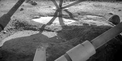 The Robotic Arm Camera on NASA's Phoenix Mars Lander took this image on Oct. 18, 2008. The flat patch in the center of the image has the informal name 'Holy Cow,' based on researchers' reaction when they first saw it.