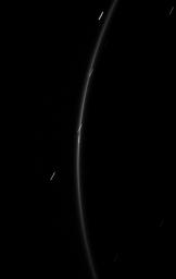 The faint G ring surrounding Saturn offers up a glimpse of its newfound tiny moonlet in this image from NASA's Cassini spacecraft taken on Feb. 20, 2009.