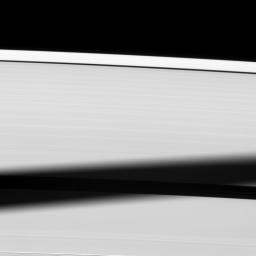 The shadow of Saturn's icy moon Tethys is cast onto Saturn's A ring, almost blanketing the Enke Gap. This image is from NASA's Cassini spacecraft.