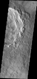 This image from NASA's Mars Odyssey shows dark slope streaks within a crater in Terra Sirenum. Wind erosion of materials on the floor of the crater.