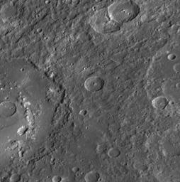 The large crater extending out the left side of this image is Praxiteles. Named for the ancient Greek sculptor of the 4th century BC, Praxiteles crater was first observed by NASA's Mariner 10.