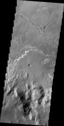 This image from NASA's 2001 Mars Odyssey shows a delta deposit on the floor of Holden Crater. This delta was formed by small channels dissecting the rim of the crater, rather than the influx of material from Uzboi Vallis.