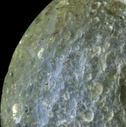 A false-color view of Saturn's moon Mimas from NASA's Cassini spacecraft accentuates terrain-dependent color differences and shows dark streaks running down the sides of some of the craters on the region of the moon that leads in its orbit around Saturn.