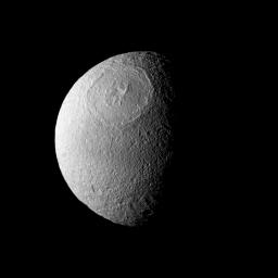 Odysseus Crater, with a size of epic proportions, stretches across a large northern expanse on Saturn's moon Tethys in this image taken by NASA's Cassini spacecraft.