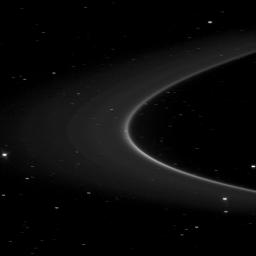 NASA's Cassini spacecraft image holds an unseen treasure orbiting within the bright arc of Saturn's G ring: the tiny moonlet Aegaeon. Too small to be seen here, it is thought to be the source of the debris forming the bright arc in the lower right.