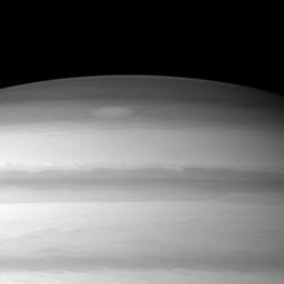 A large cloud formation swirls through the high northern latitudes of Saturn near the top of this image taken by NASA's Cassini spacecraft.