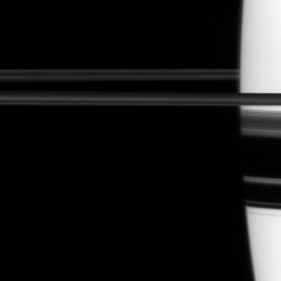 NASA's Cassini spacecraft looks toward the limb of Saturn and, on the right of this image, views part of the rings through the planet's atmosphere. Saturn's atmosphere can distort the view of the rings from some angles.