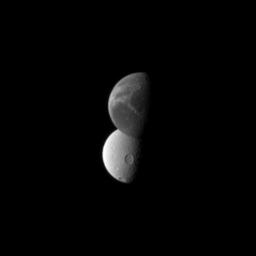 Saturn's 'wispy' moon Dione lies in front of the cratered surface of the moon Tethys, as seen by NASA's Cassini spacecraft. Dione is closest to the spacecraft here.