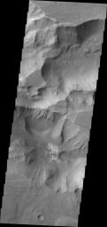 This image from NASA's 2001 Mars Odyssey spacecraft shows a small portion of the floor of Coprates Catena, just south of the Valles Marineris canyon system. The lighter toned materials in the center of the image are layered deposits.