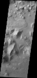 The landslide deposit in this image captured by NASA's 2001 Mars Odyssey spacecraft is located in Aurorae Chaos (distinctive area of broken terrain). Several regions of chaotic terrain are located on the eastern end of the Valles Marineris system.